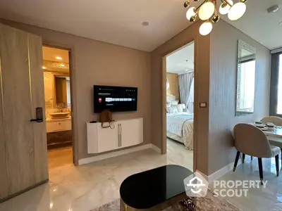 Elegant modern apartment interior showcasing a seamless transition from a cozy living area to a luxurious bedroom with sophisticated furnishings and tasteful decor.