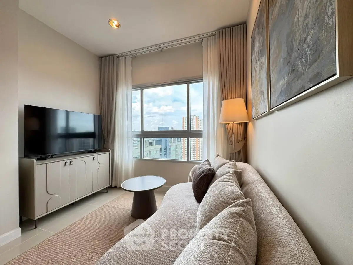 Modern living room with cozy sofa, large window, and flat-screen TV, offering a bright and inviting atmosphere.