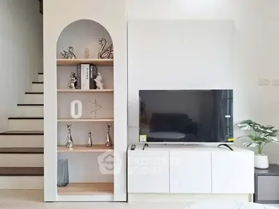 Modern living room with stylish TV unit and decorative shelving