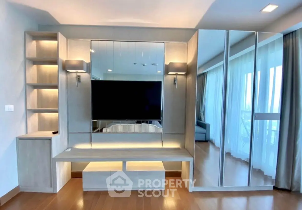 Modern living room with sleek built-in entertainment center and mirrored storage
