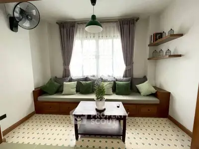 Charming living room with cozy seating and stylish decor, perfect for relaxation.