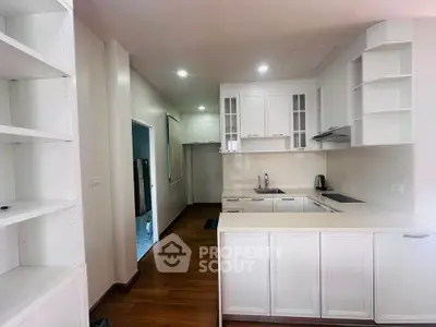 Modern kitchen with white cabinetry and open layout in a stylish apartment