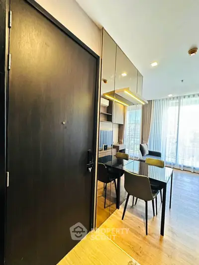 Modern living room with sleek furniture and large windows offering natural light.