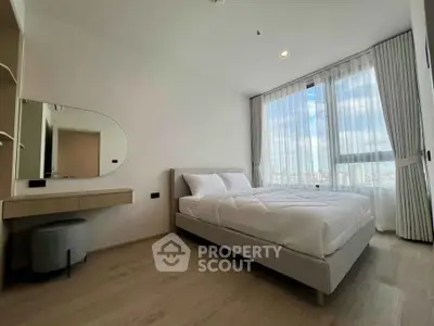 Modern bedroom with large window and stylish decor in a high-rise apartment.