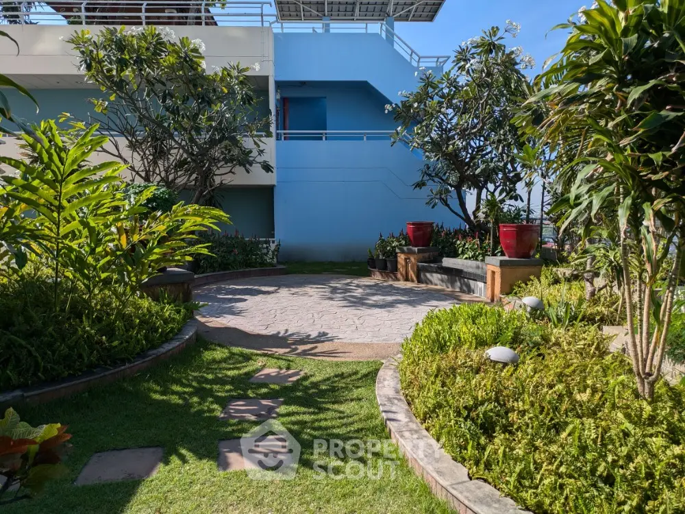 Beautiful garden area with lush greenery and seating, perfect for relaxation and outdoor enjoyment.
