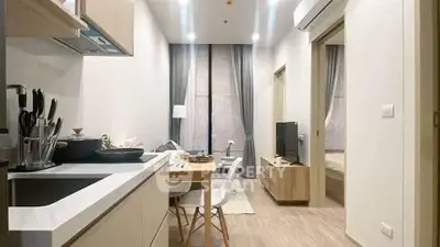 Modern open-layout kitchen and living room with sleek design and cozy ambiance.