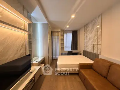 Modern bedroom with stylish decor and cozy seating area