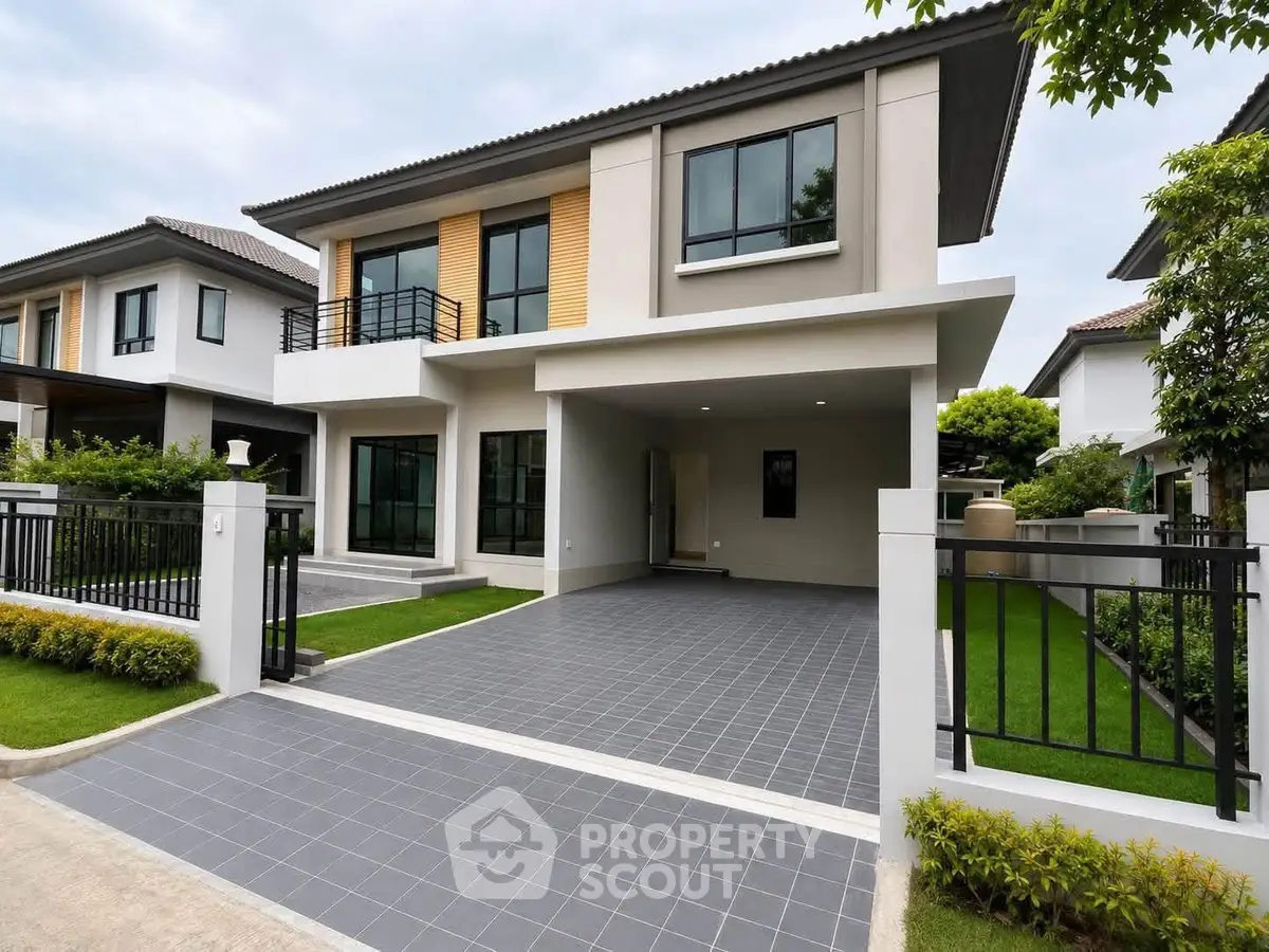 Modern two-story house with spacious driveway and lush green lawn in a serene neighborhood.