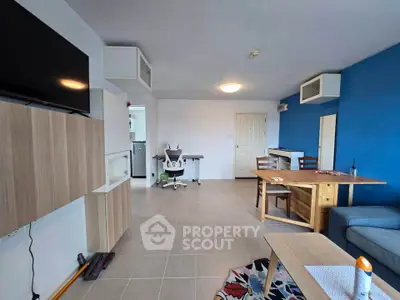 Spacious modern living room with blue accent wall and stylish furniture