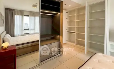 Spacious bedroom with modern closet and large windows offering city views.
