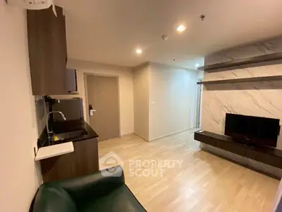 Modern living room with sleek design, featuring a wall-mounted TV and stylish shelving.