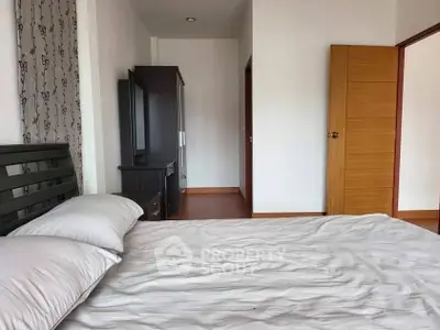 Spacious bedroom with modern furniture and natural light