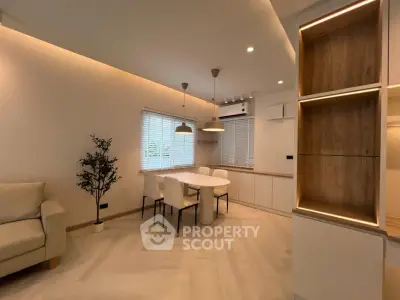 Modern living room with elegant dining area and stylish lighting