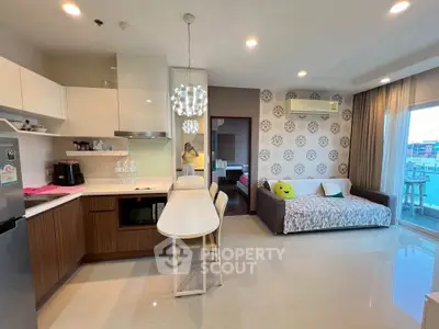 Modern open-layout kitchen and living area with stylish decor and natural light.