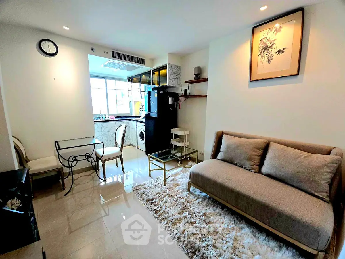 Modern living room with cozy sofa and dining area, open kitchen layout, and stylish decor.