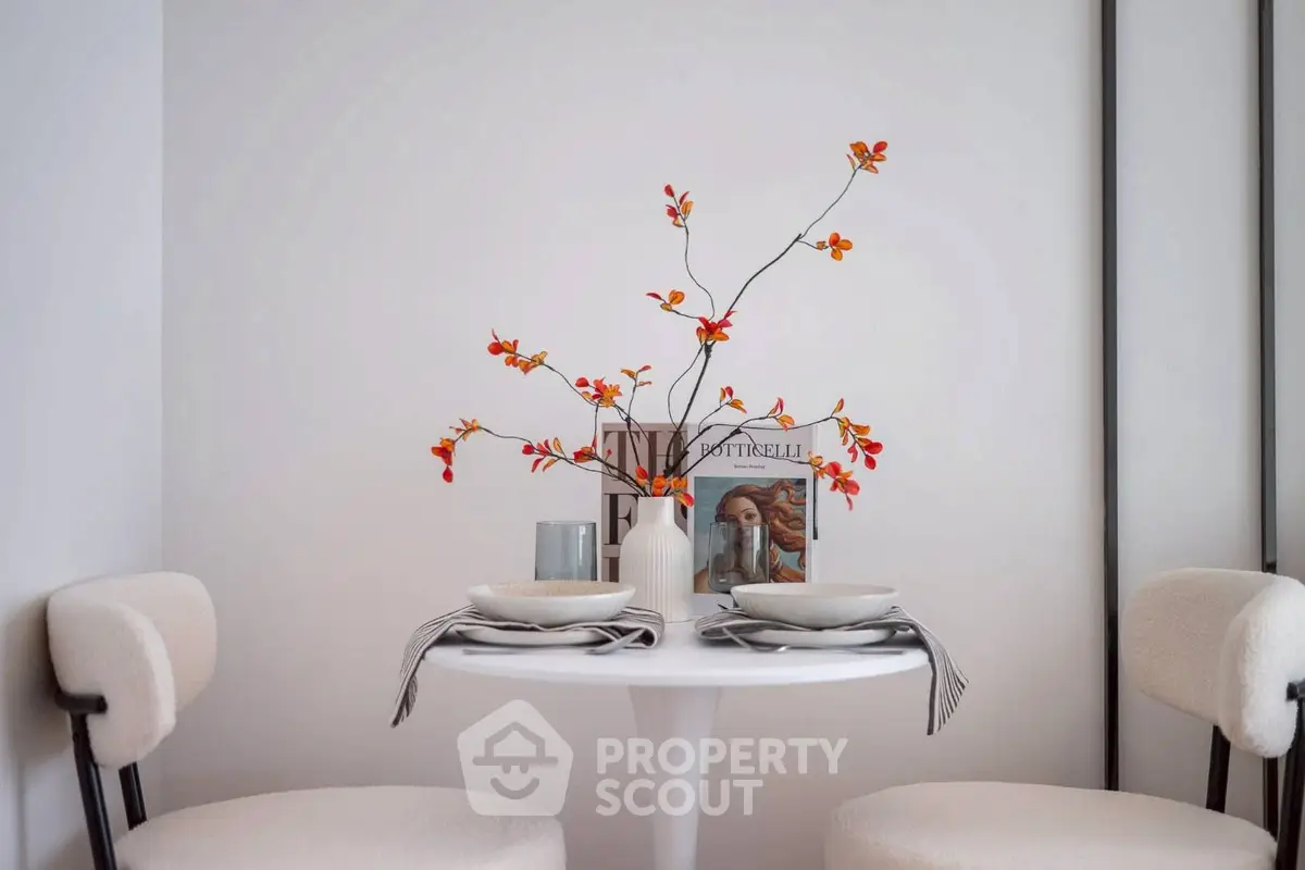 Chic dining nook with modern decor and elegant table setting in a cozy apartment.