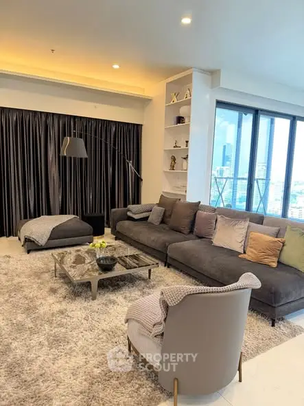 Luxurious living room with plush seating and city view, perfect for relaxation and entertaining.