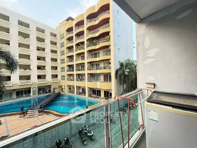 Spacious balcony with pool view in modern apartment complex