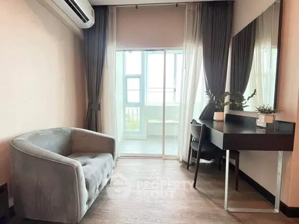 Chic modern living room with cozy seating and stylish decor, featuring large windows for natural light.