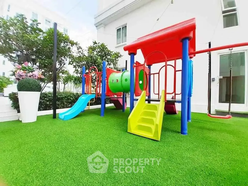 Vibrant outdoor playground with slides and climbing structures in a residential complex.