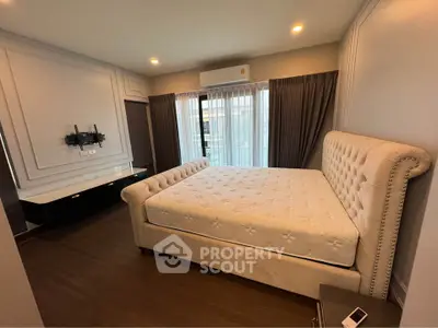 Luxurious bedroom with elegant decor and large windows in modern apartment