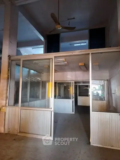 Spacious commercial property with glass partitions and high ceilings, ideal for office or retail use.