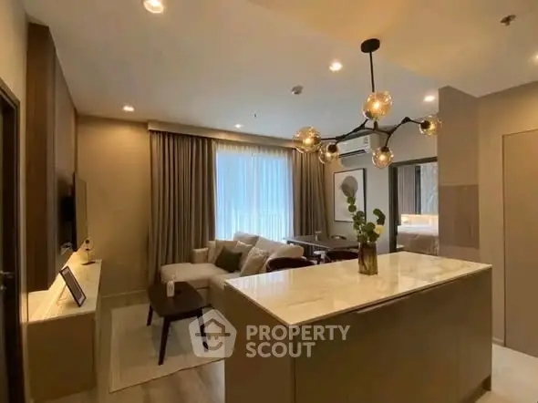 Modern open-layout living room with stylish lighting and cozy seating area