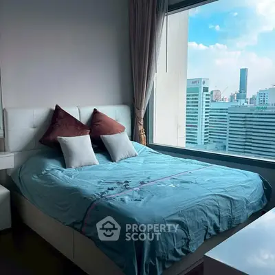 Modern bedroom with large window offering stunning city view