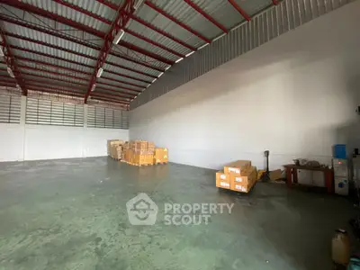 Spacious warehouse interior with high ceiling and ample storage space