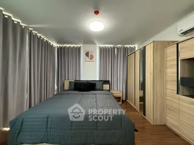 Modern bedroom with stylish decor and ample natural light