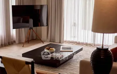 Modern living room with stylish decor and large flat-screen TV, perfect for relaxation and entertainment.