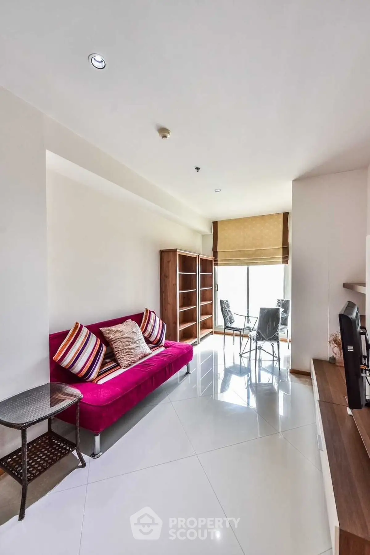 Modern living room with vibrant sofa and natural light