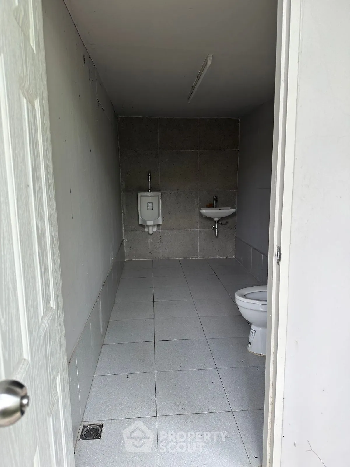 Compact and functional bathroom with essential fixtures in minimalist design.