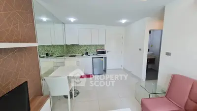 Modern open-layout kitchen and living area with sleek design and contemporary furniture.