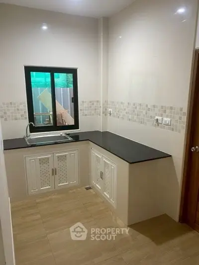 Modern kitchen with sleek countertops and stylish cabinetry, perfect for culinary enthusiasts.