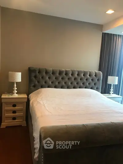 Luxurious bedroom with elegant tufted headboard and stylish bedside lamps