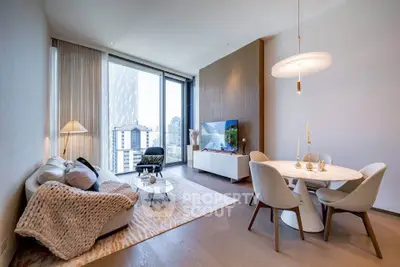 Modern living room with city view, elegant furniture, and stylish decor in a high-rise apartment.