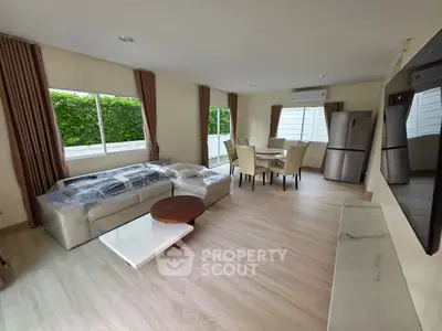Spacious modern living room with elegant dining area and large windows