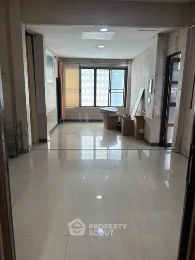 Spacious interior with large windows and tiled flooring, ideal for customization.