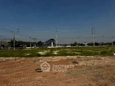 Expansive vacant land with clear sky, ideal for development opportunities.