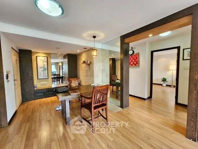 Spacious open-plan living area with wooden flooring and elegant decor
