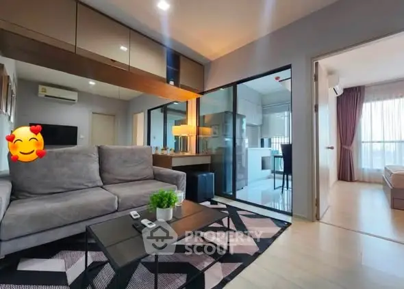 Modern living room with stylish decor and open layout leading to a bright bedroom.
