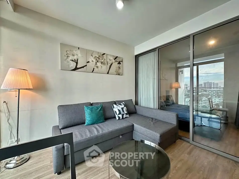 Modern living room with stylish decor and city view from balcony