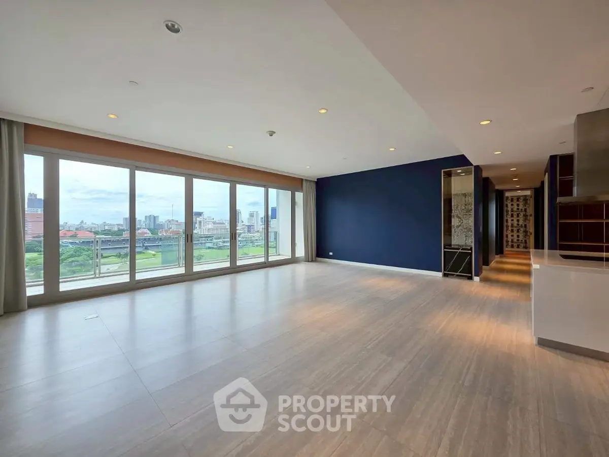 Spacious modern living room with large windows and city view
