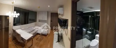 Modern apartment interior with open living room and bathroom view