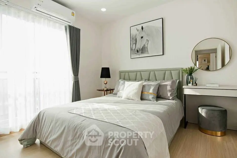 Elegant bedroom with stylish decor, featuring a cozy bed, modern furniture, and natural light from large window.