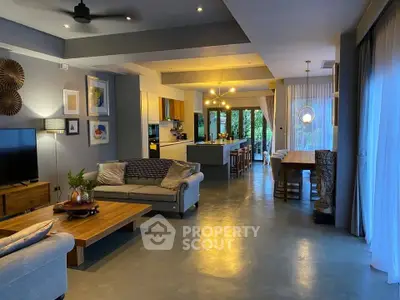Spacious open-plan living and dining area with modern decor and large windows.