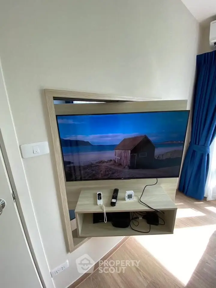 Modern living room with wall-mounted TV and scenic view