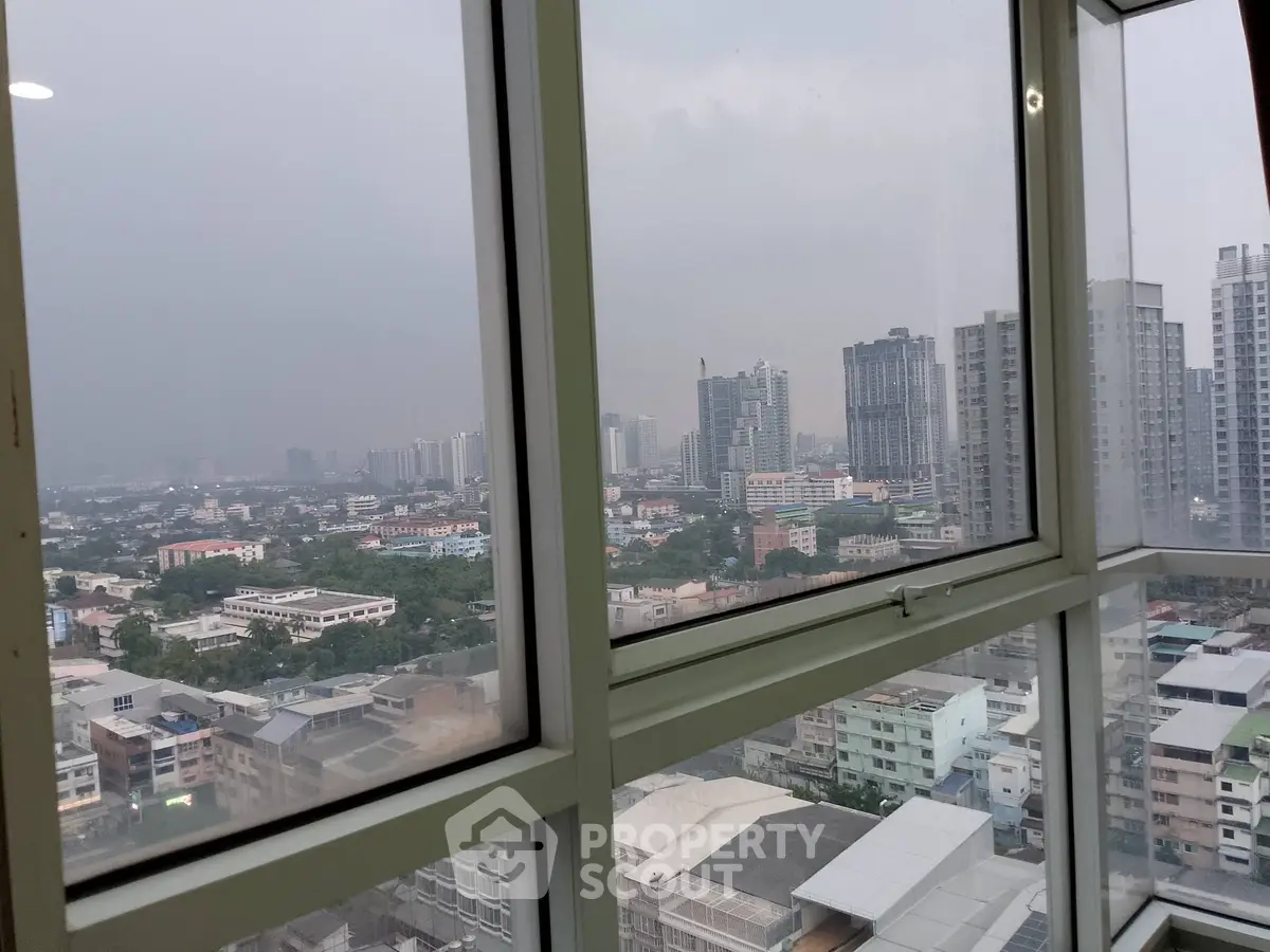 Stunning cityscape view from high-rise window showcasing urban skyline.