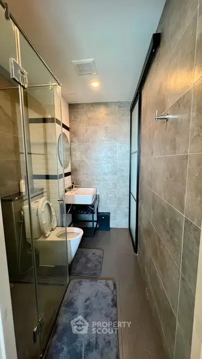 Modern bathroom with glass shower and sleek tile design